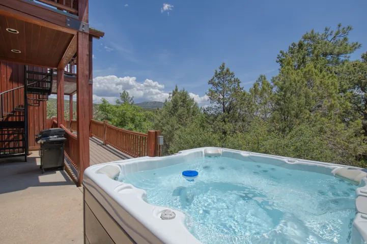 Deck with a hot tub and grilling area