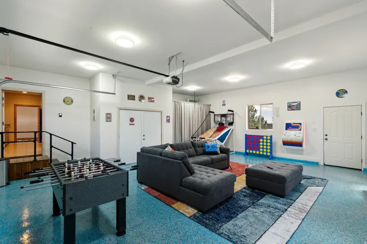 Game room featuring speckled floor and a garage