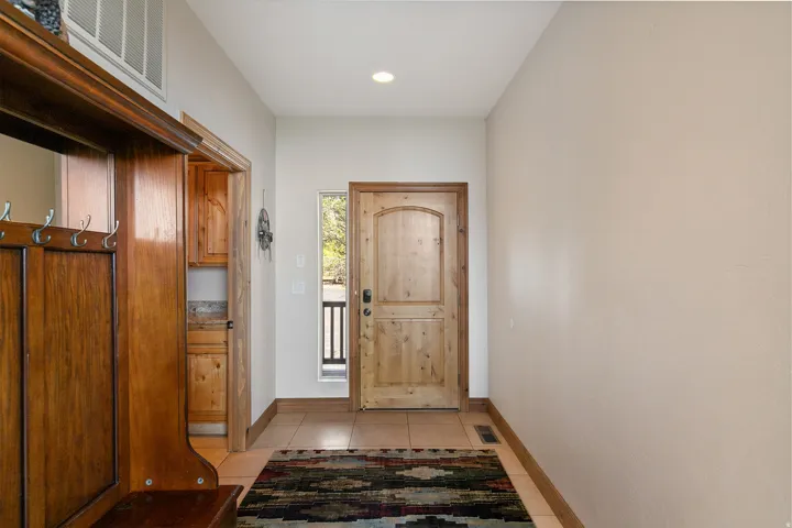 Doorway featuring tile patterned floors and recessed lighting