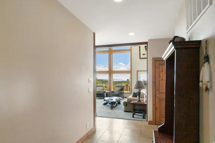 Corridor with recessed lighting and light tile patterned flooring