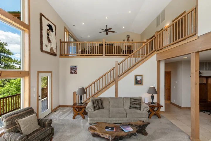 Living area featuring a ceiling fan, recessed lighting, and lofted ceiling