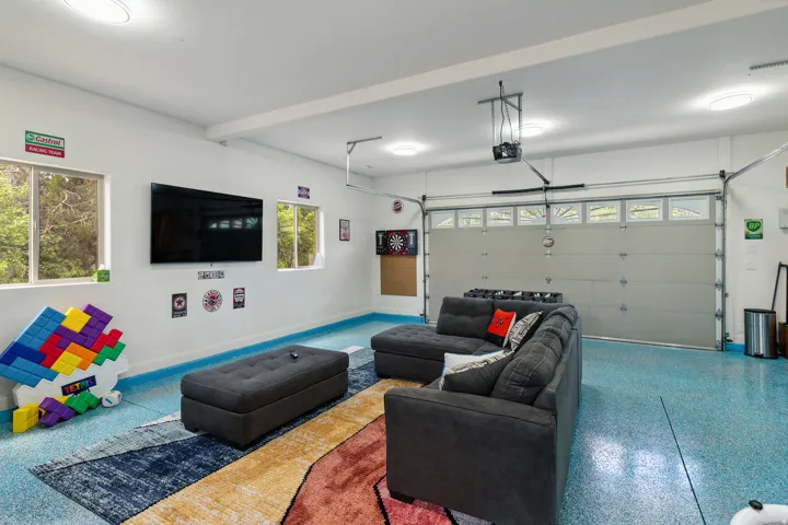 Living room with a garage and speckled floor