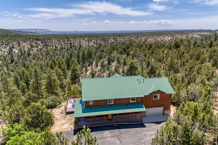 View of subject property featuring a forest
