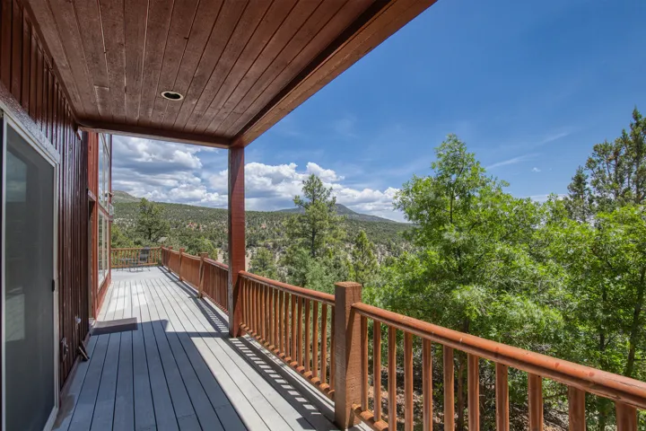 Deck with a forest view and a mountain view