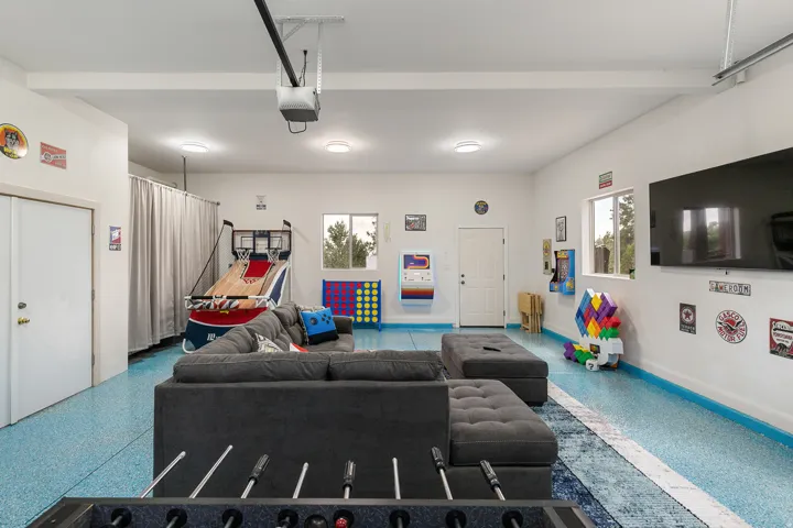 Living room featuring speckle patterned floor and a garage