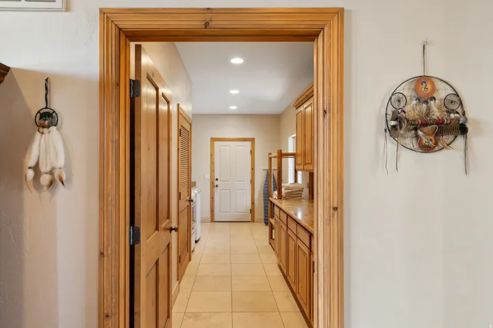 Hallway with recessed lighting and light tile patterned floors