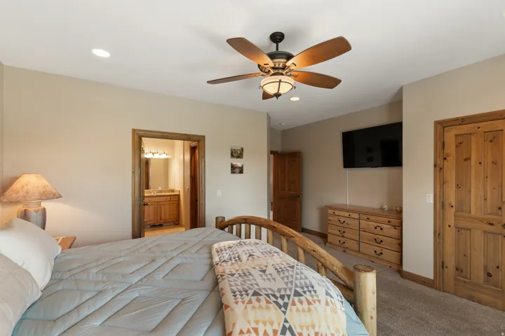 Bedroom featuring carpet flooring, connected bathroom, ceiling fan, and recessed lighting