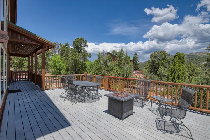 Wooden deck with outdoor dining space and a fire pit