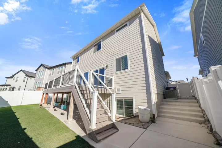Rear view of property with a fenced backyard, a wooden deck, a patio area, and a residential view