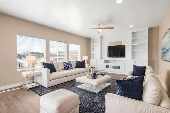 ** virtual staging ** Living area featuring wood laminate floors, a ceiling fan, recessed lighting, and built in features