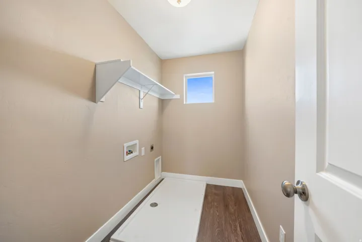 Laundry area featuring dark wood-style floors, electric dryer hookup, and washer hookup