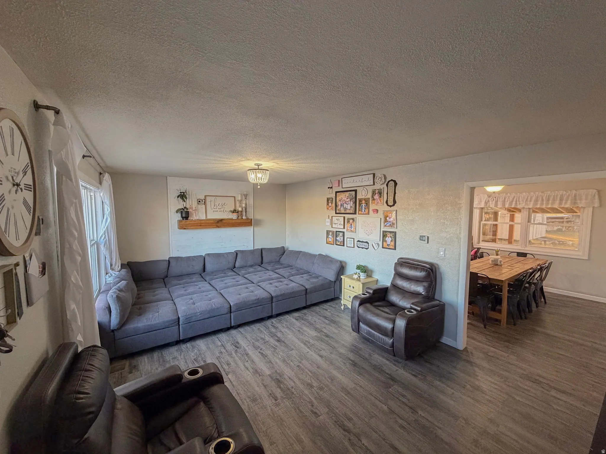 Living area featuring a textured ceiling and wood finished floors