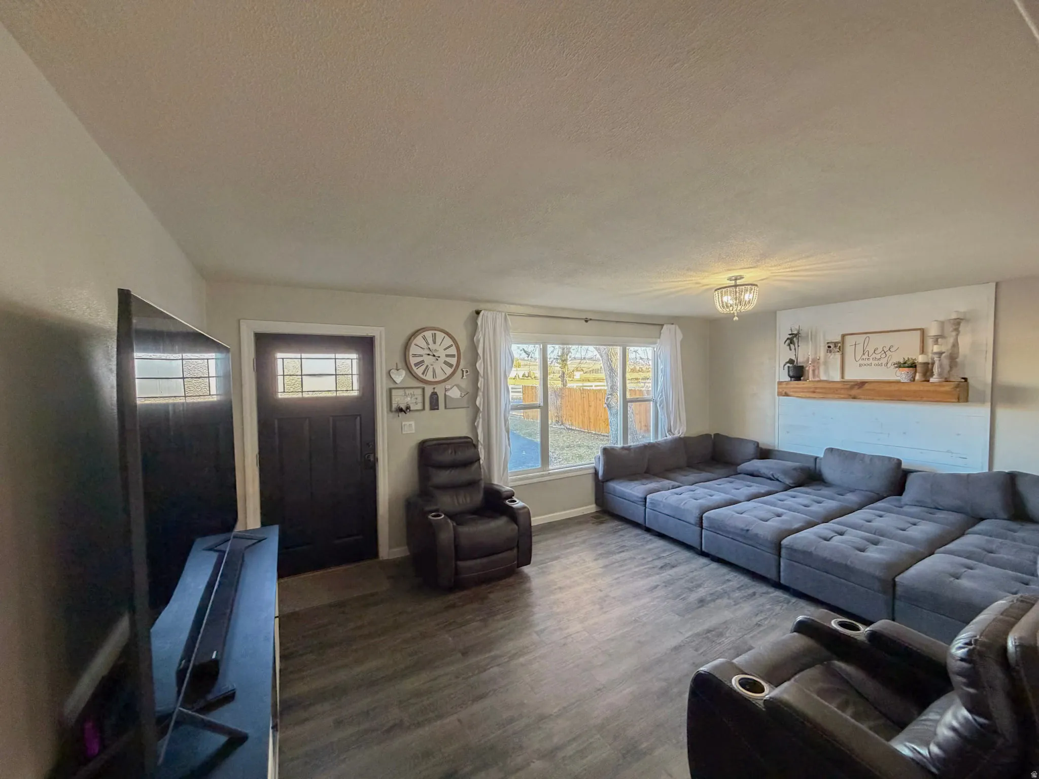 Living room with dark wood-style floors and a textured ceiling