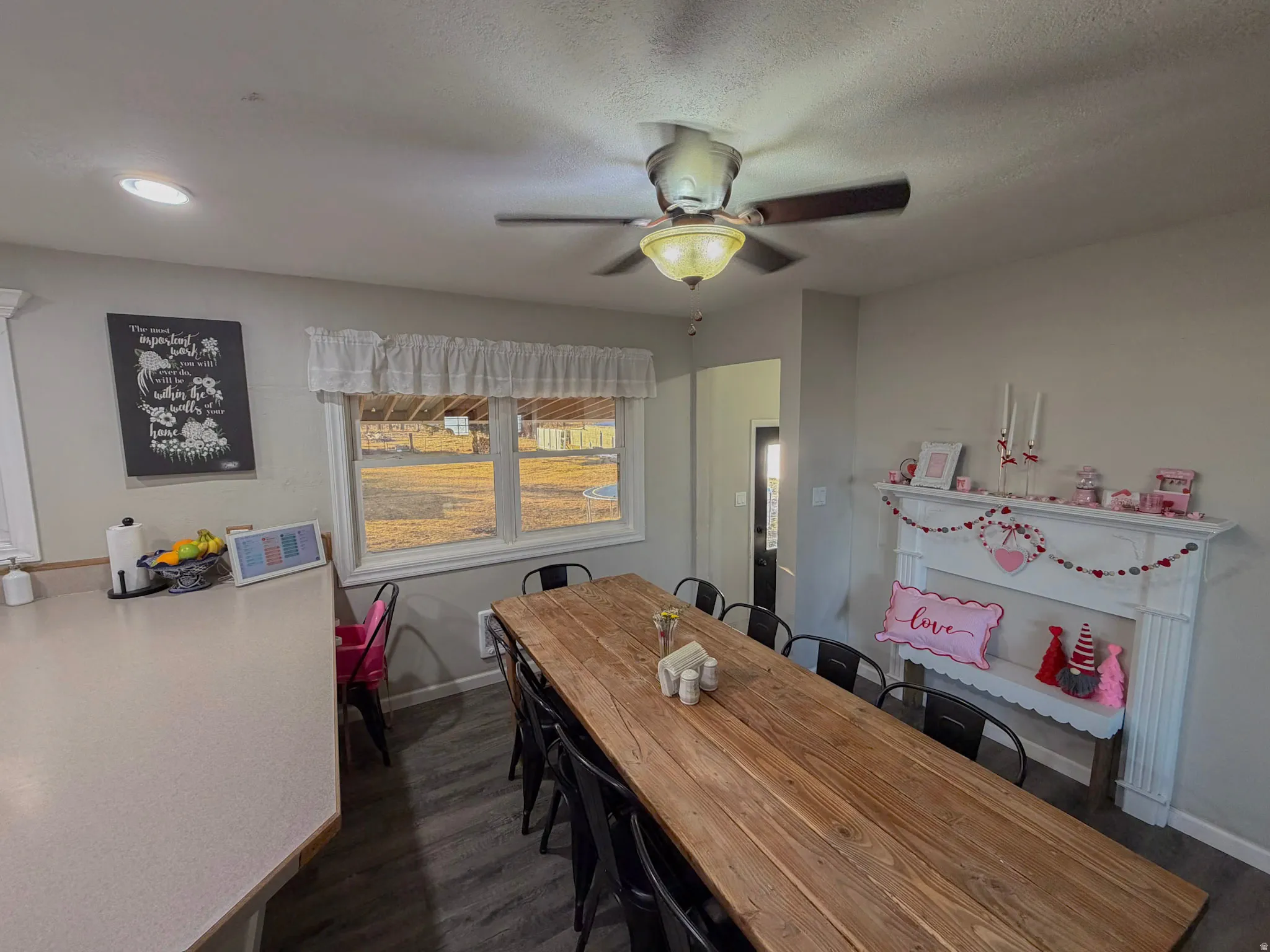 Dining area featuring dark wood finished floors and a ceiling fan