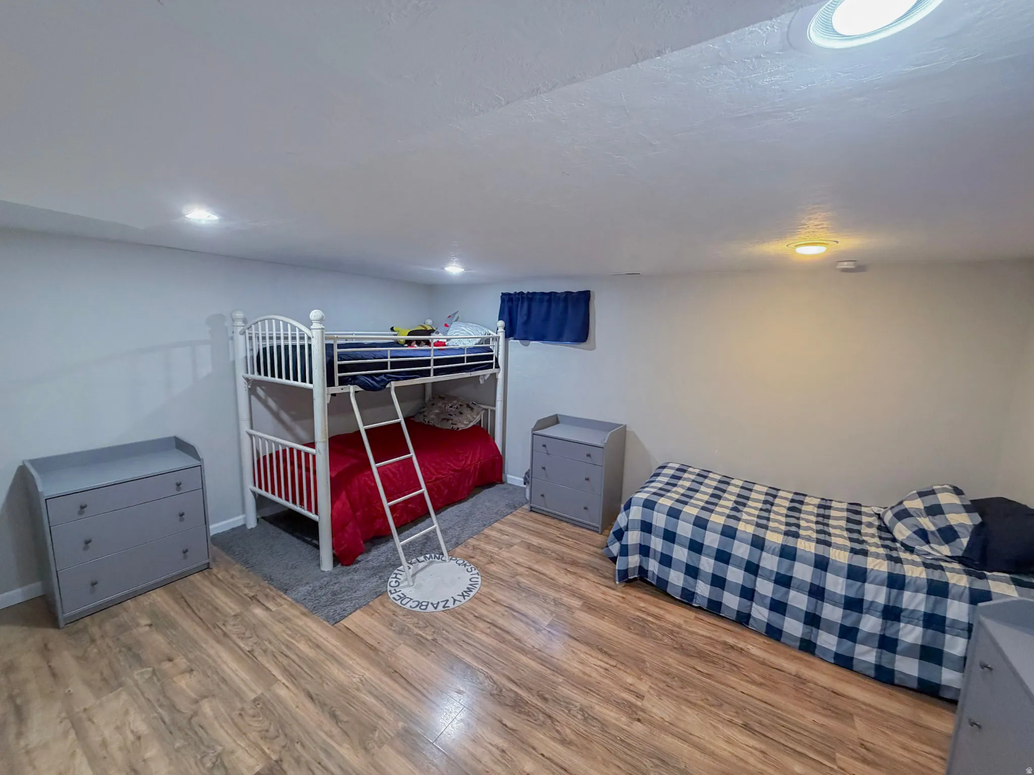 Bedroom featuring wood finished floors and a textured ceiling