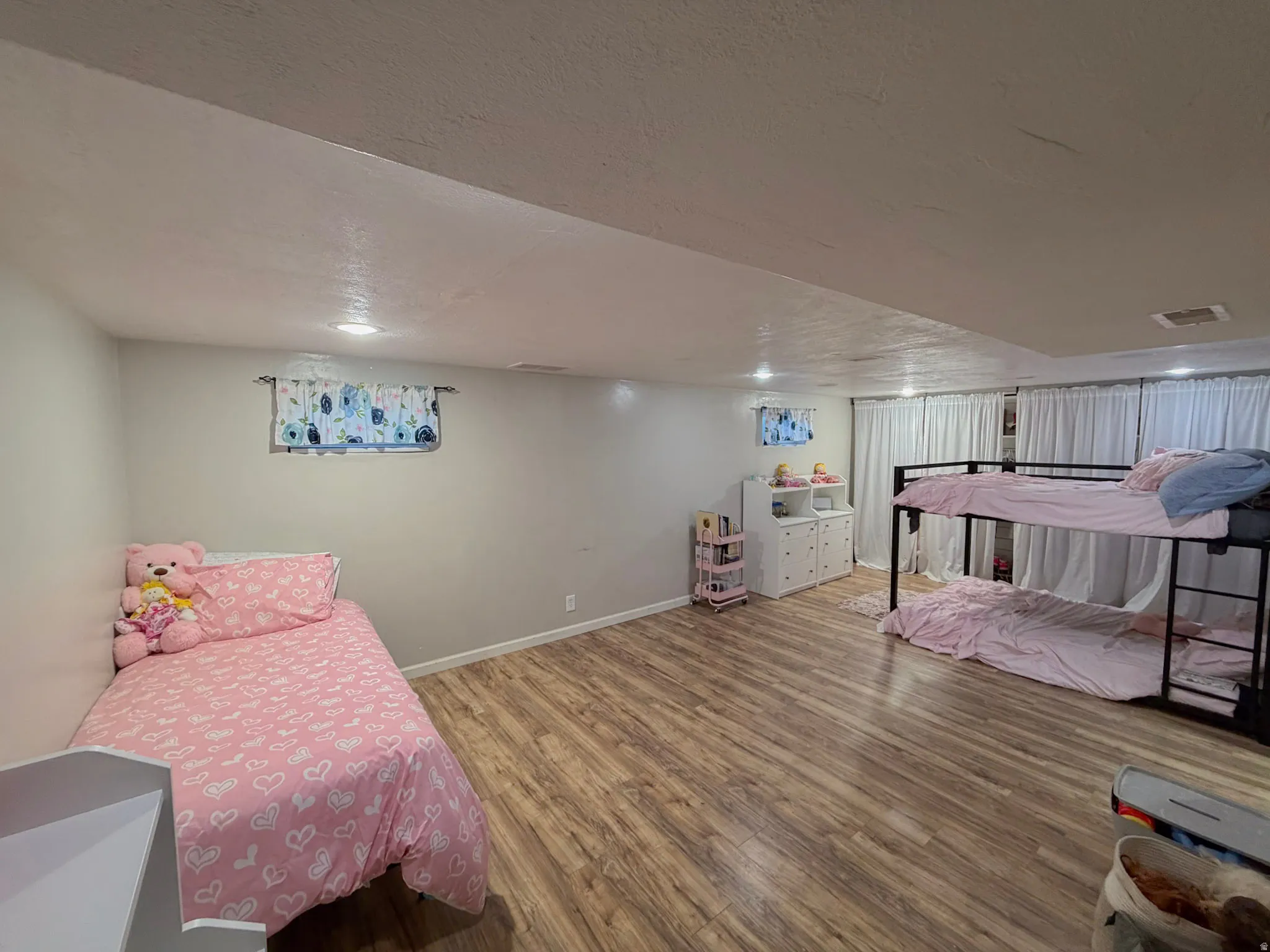 Bedroom featuring wood finished floors and baseboards