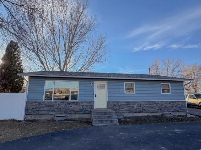 View of front of house with stone siding and entry steps
