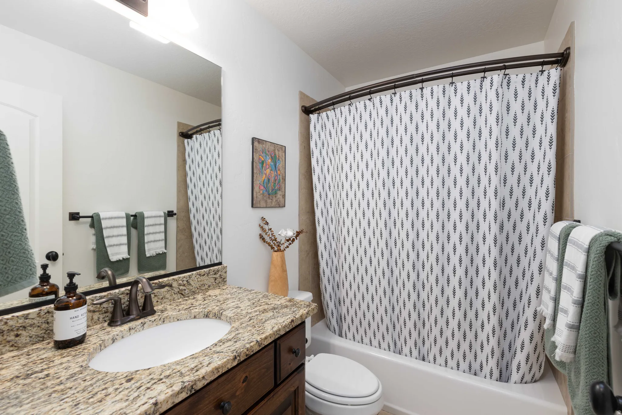 Full bath with vanity and shower / bath combination with curtain