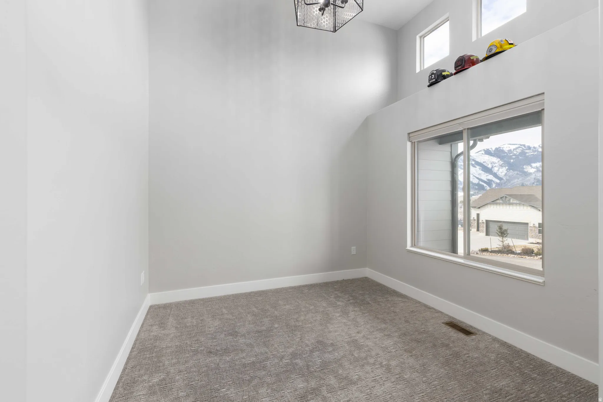 Spare room with carpet floors and a high ceiling
