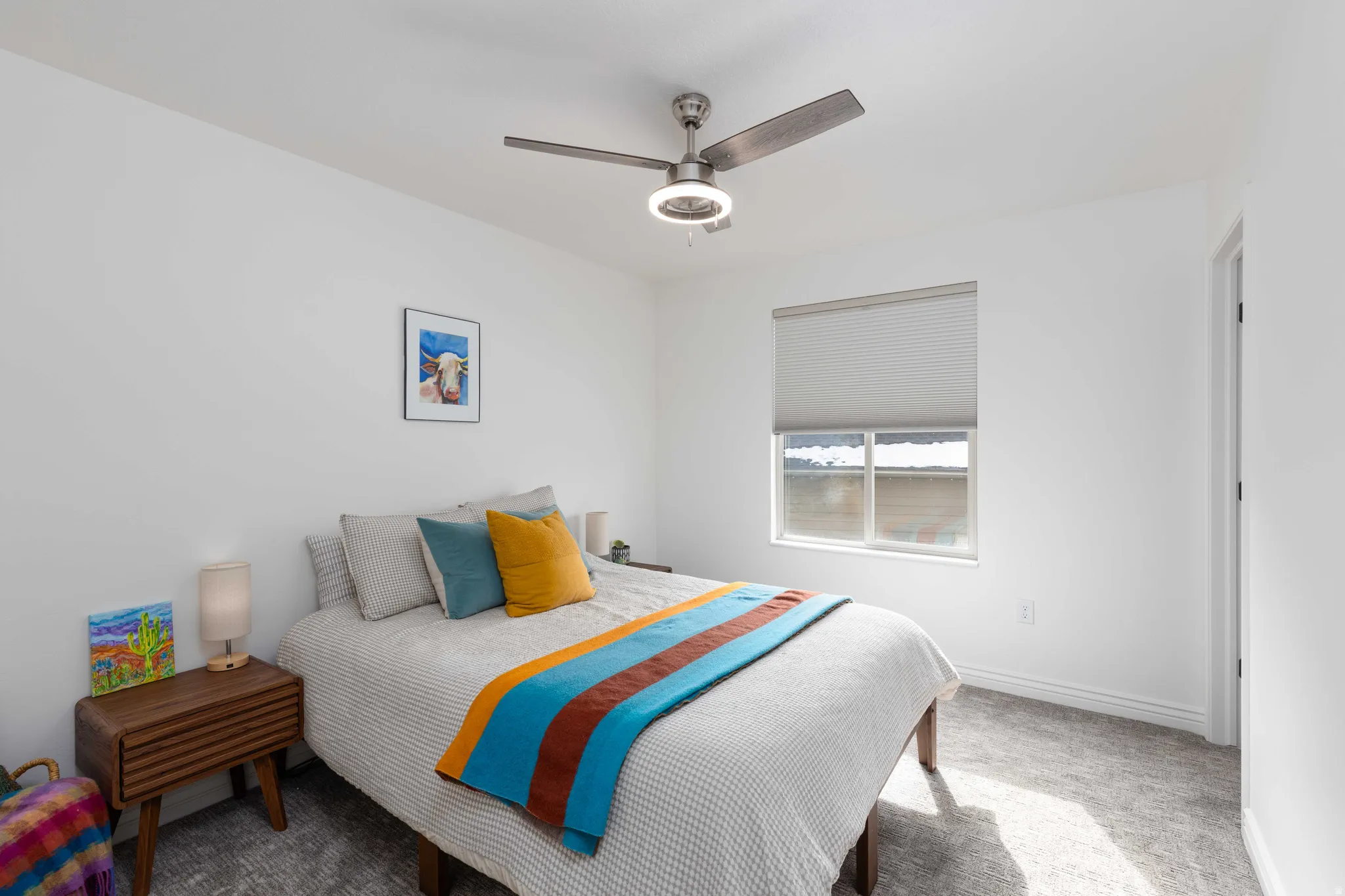Bedroom featuring light colored carpet and a ceiling fan