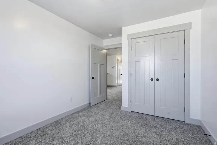 Unfurnished bedroom featuring carpet flooring and a closet
