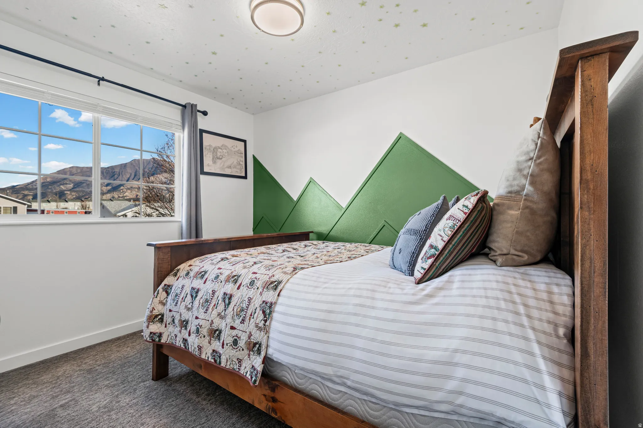 Bedroom featuring a mountain view and dark carpet