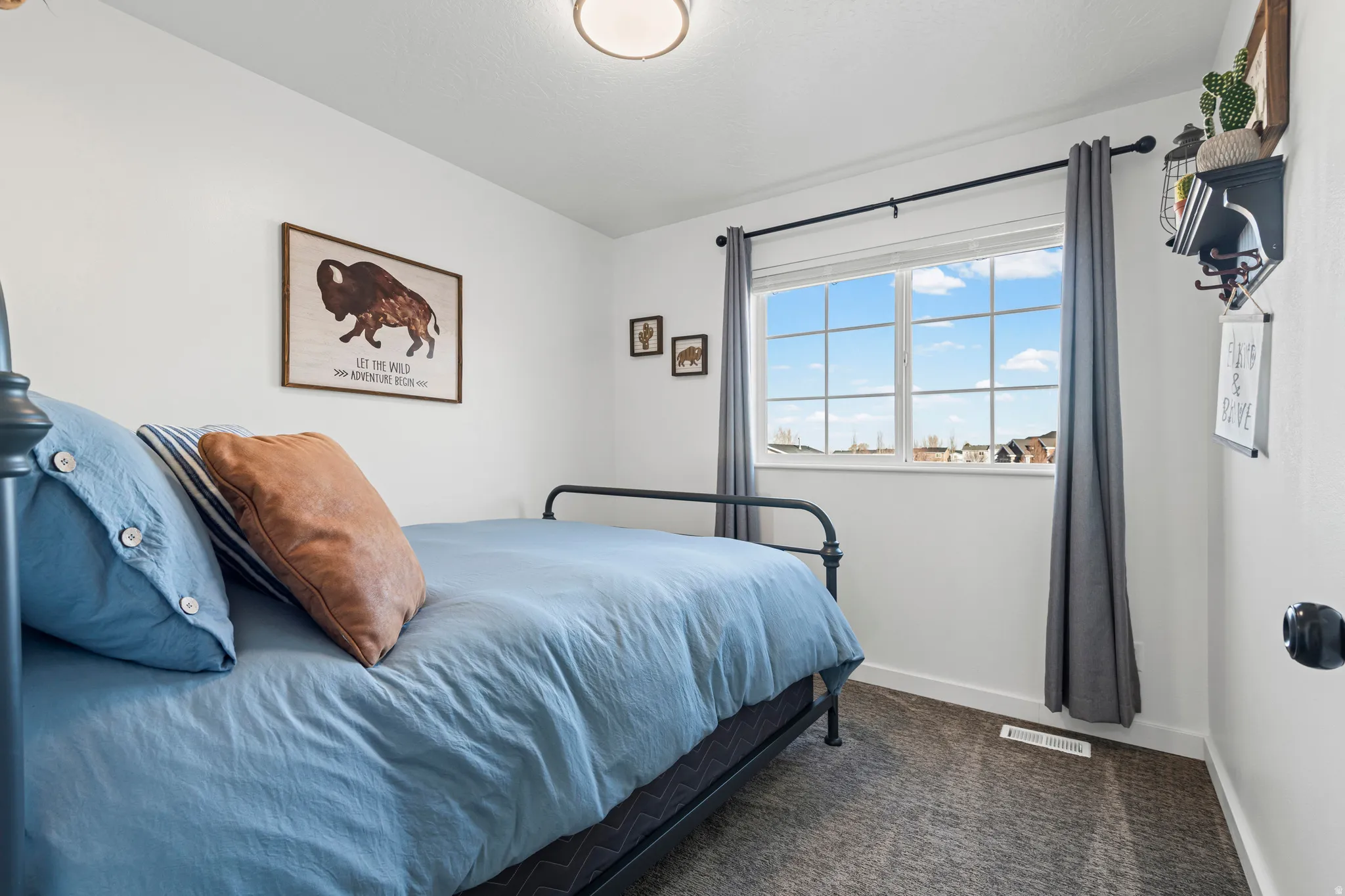 Bedroom featuring baseboards and dark colored carpet