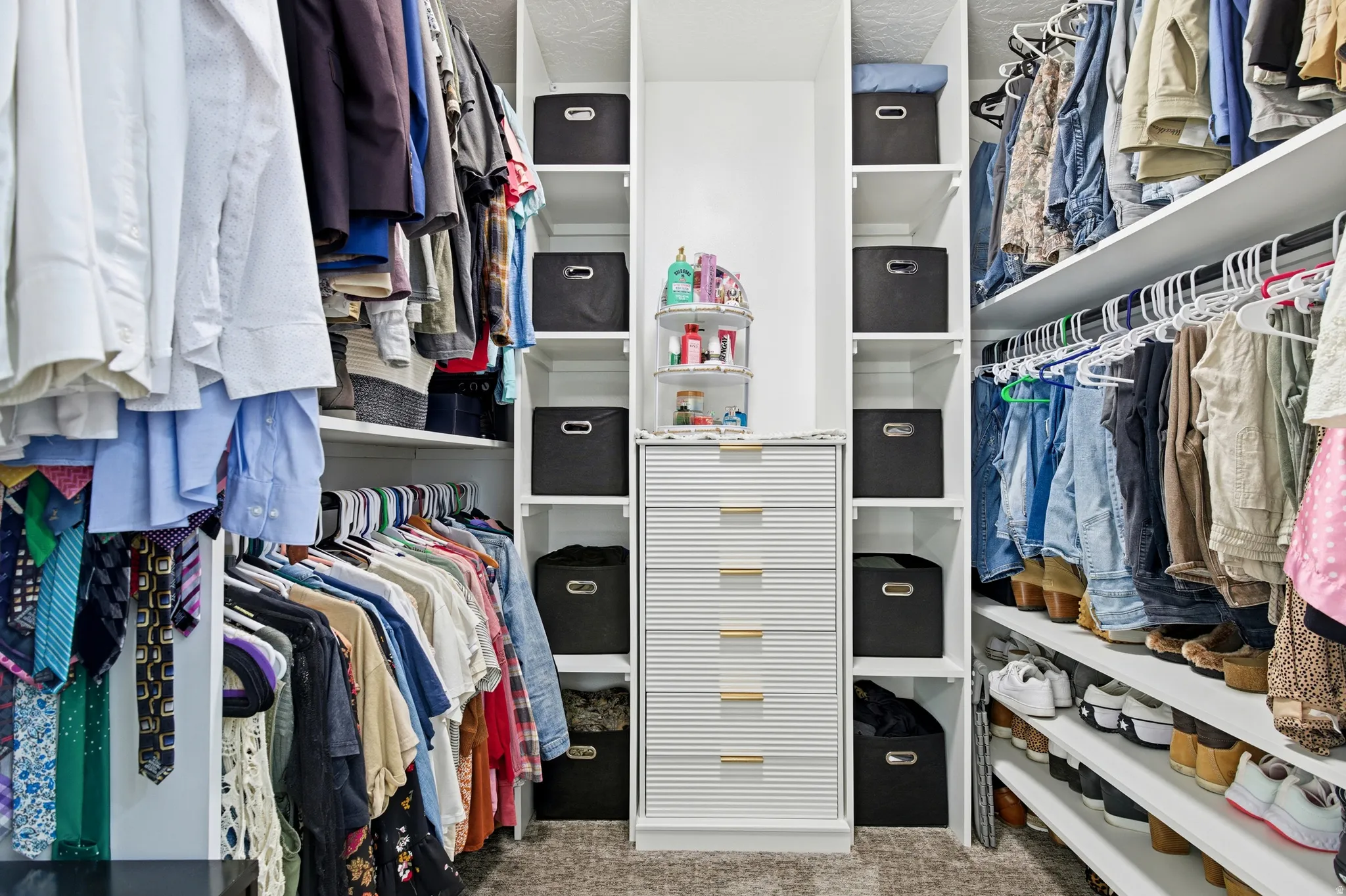 Walk in closet featuring light carpet