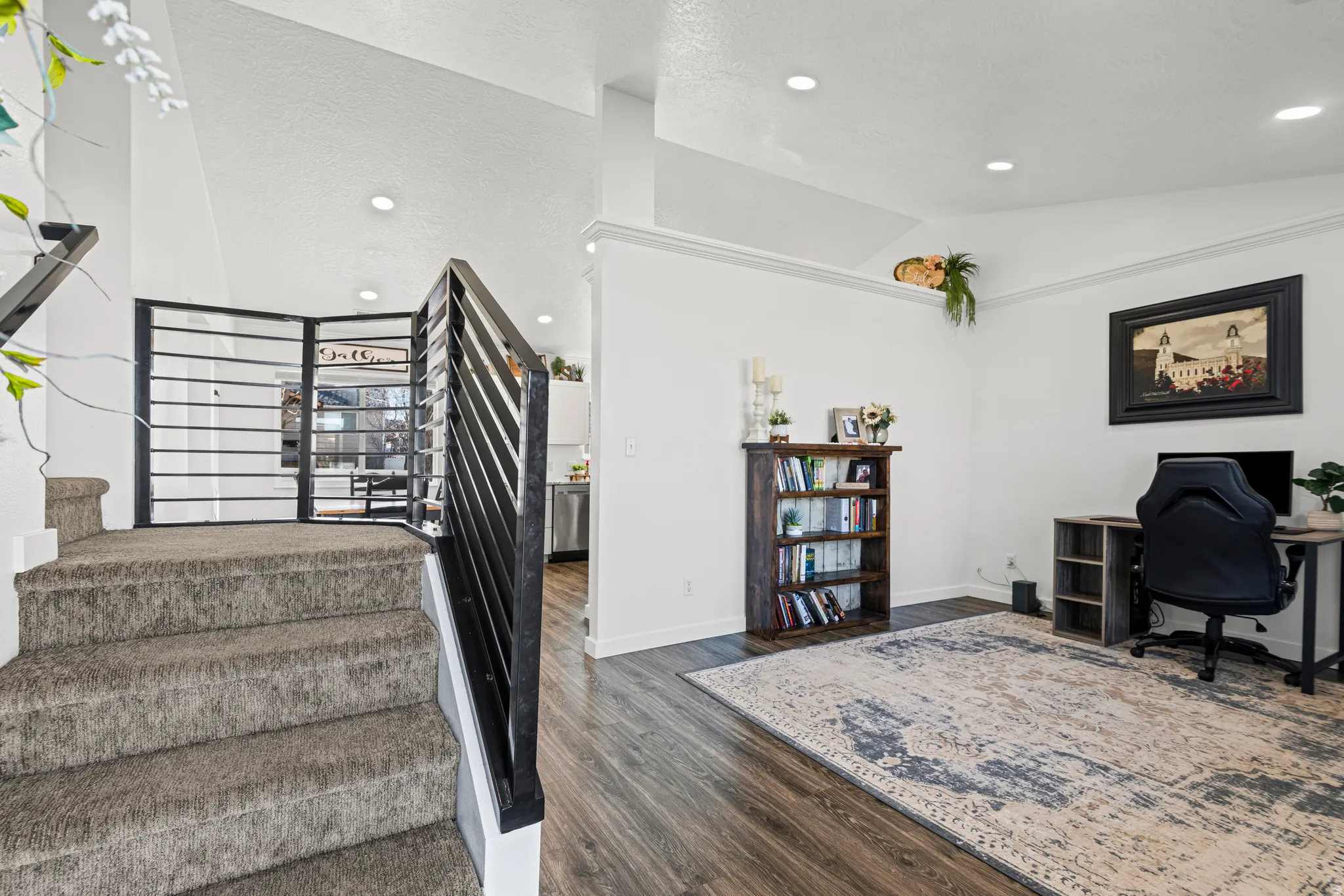 Stairs with recessed lighting and wood finished floors