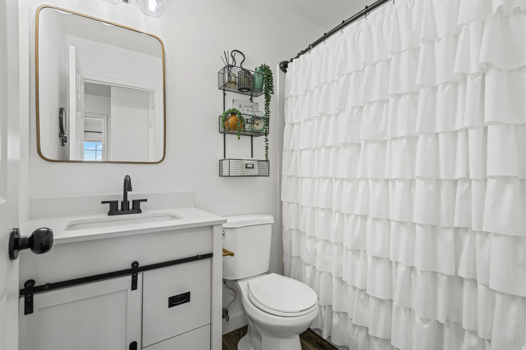 Bathroom featuring vanity and curtained shower
