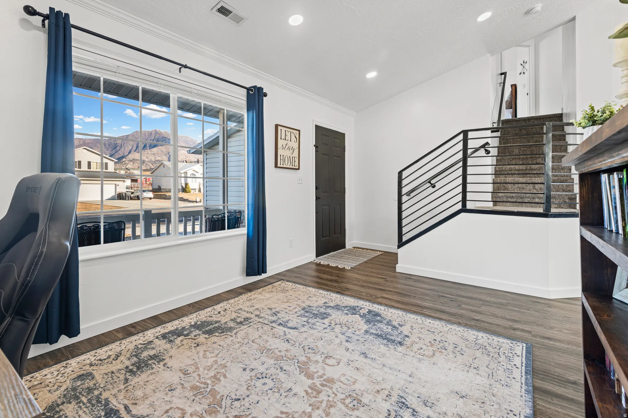 Entryway with a mountain view, dark wood-style flooring, and recessed lighting