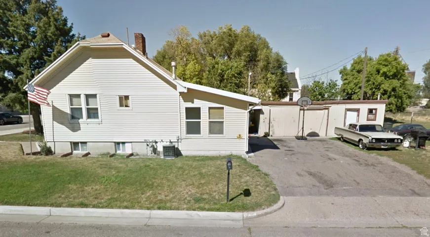 View of home's exterior featuring a yard and a chimney