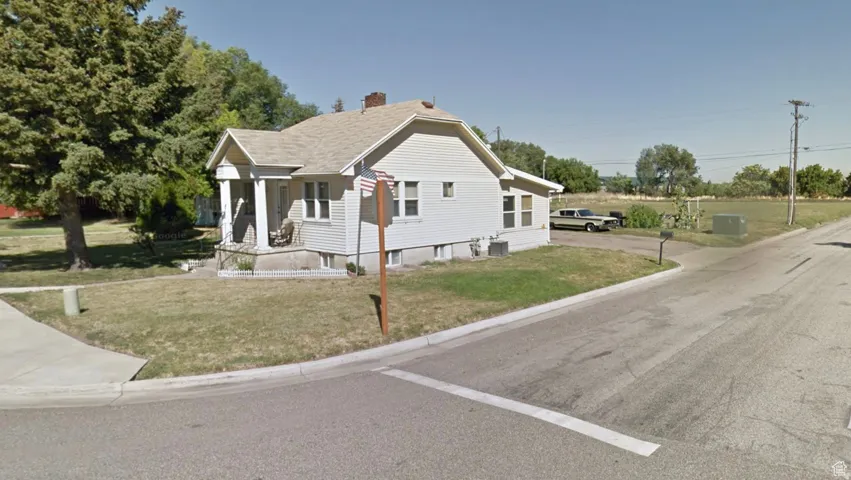 Bungalow-style house with a front yard and a chimney