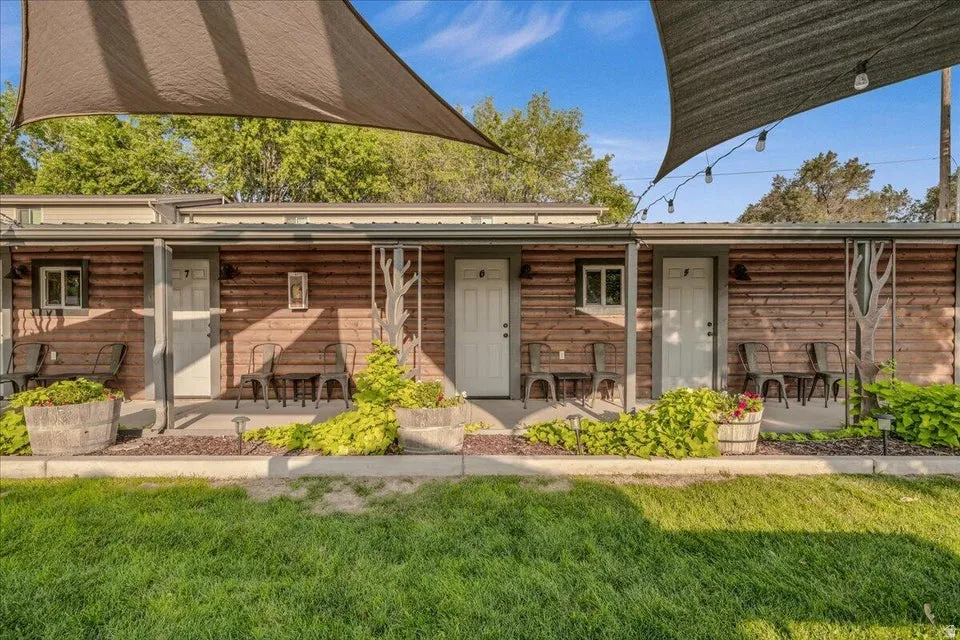 View of front of home featuring a front lawn and a porch