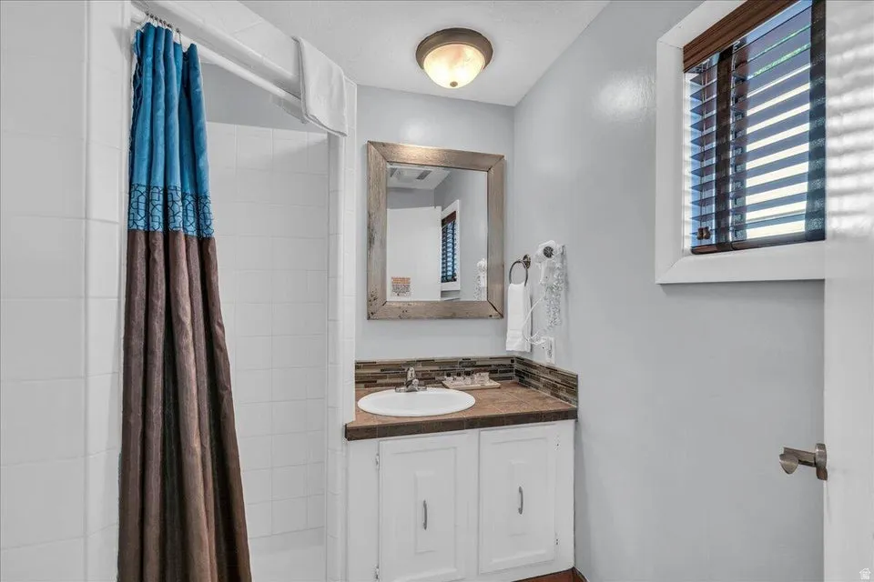 Full bathroom featuring vanity and a stall shower