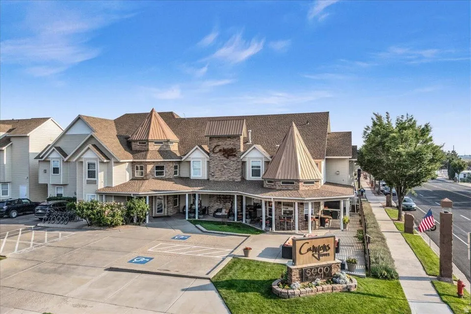 View of front of property featuring a standing seam roof and uncovered parking