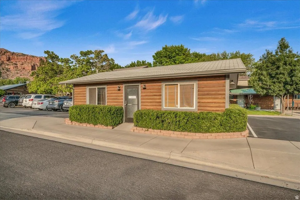 View of front facade with faux log siding