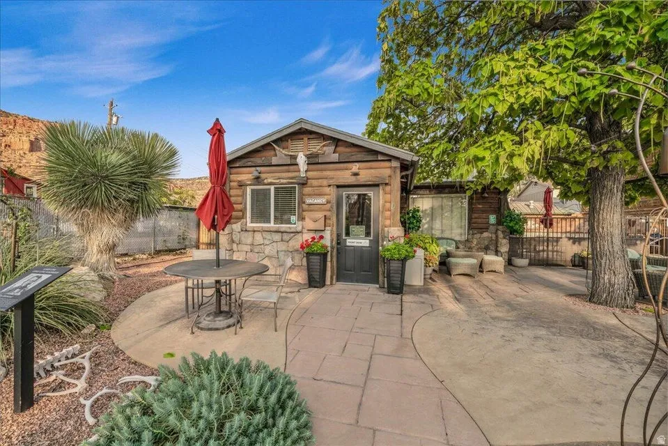 View of outbuilding featuring a fenced backyard and outdoor dining area