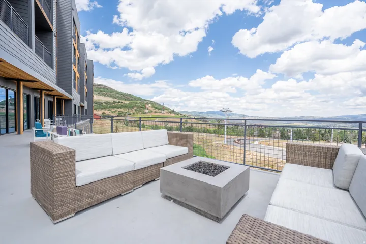 View of patio featuring an outdoor living space with a fire pit and a mountain view