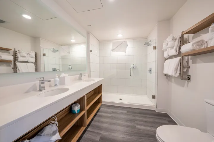 Full bath featuring a stall shower and double vanity