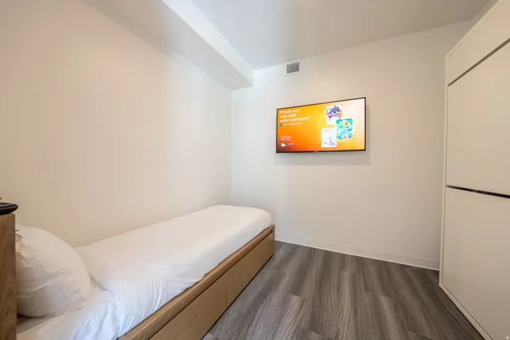 Bedroom featuring dark wood-style flooring and baseboards