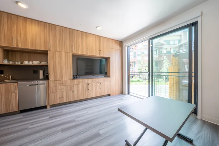 Unfurnished living room featuring light wood-type flooring and a sink