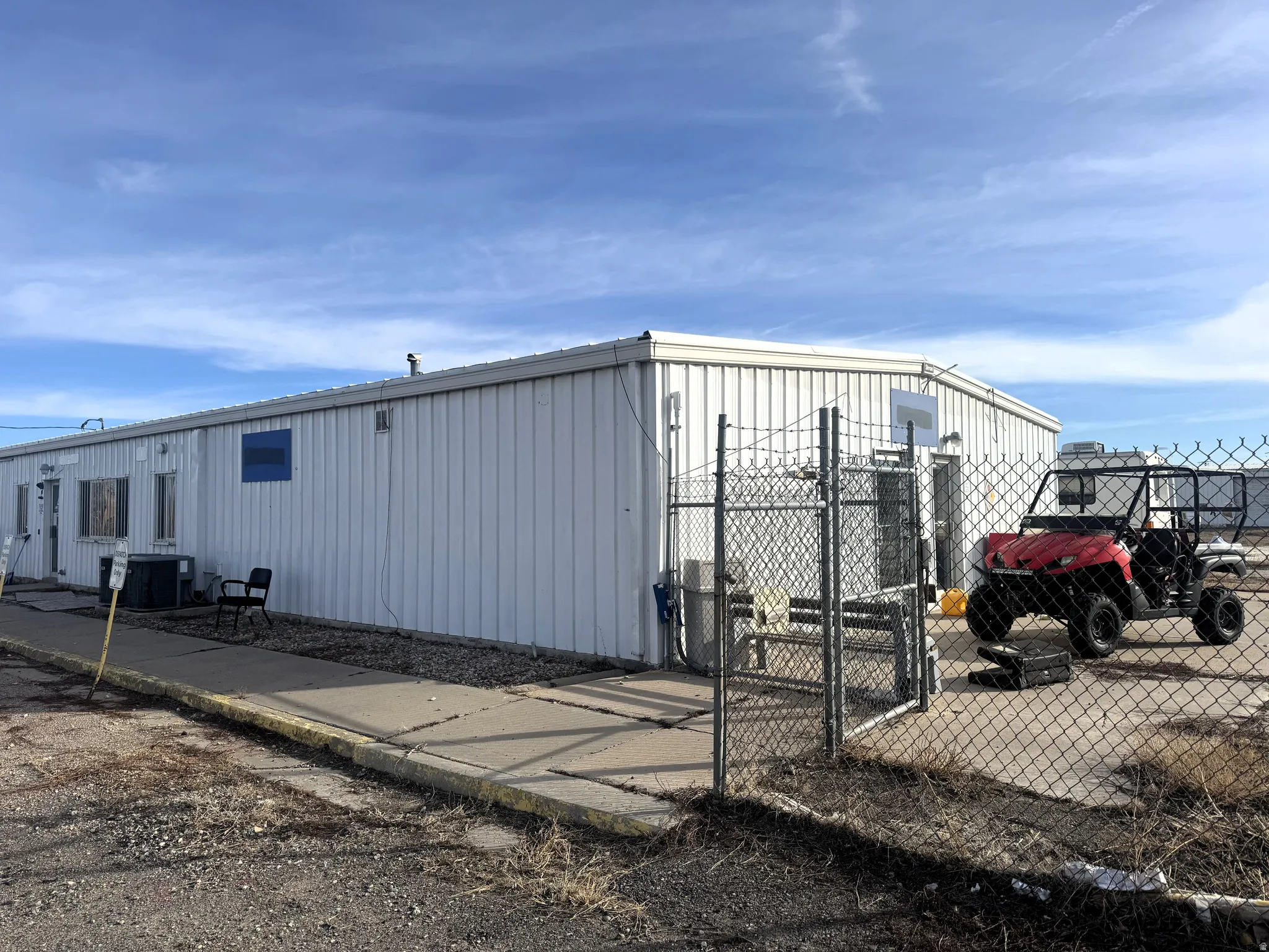 View of property exterior with a gate and a central air condition unit
