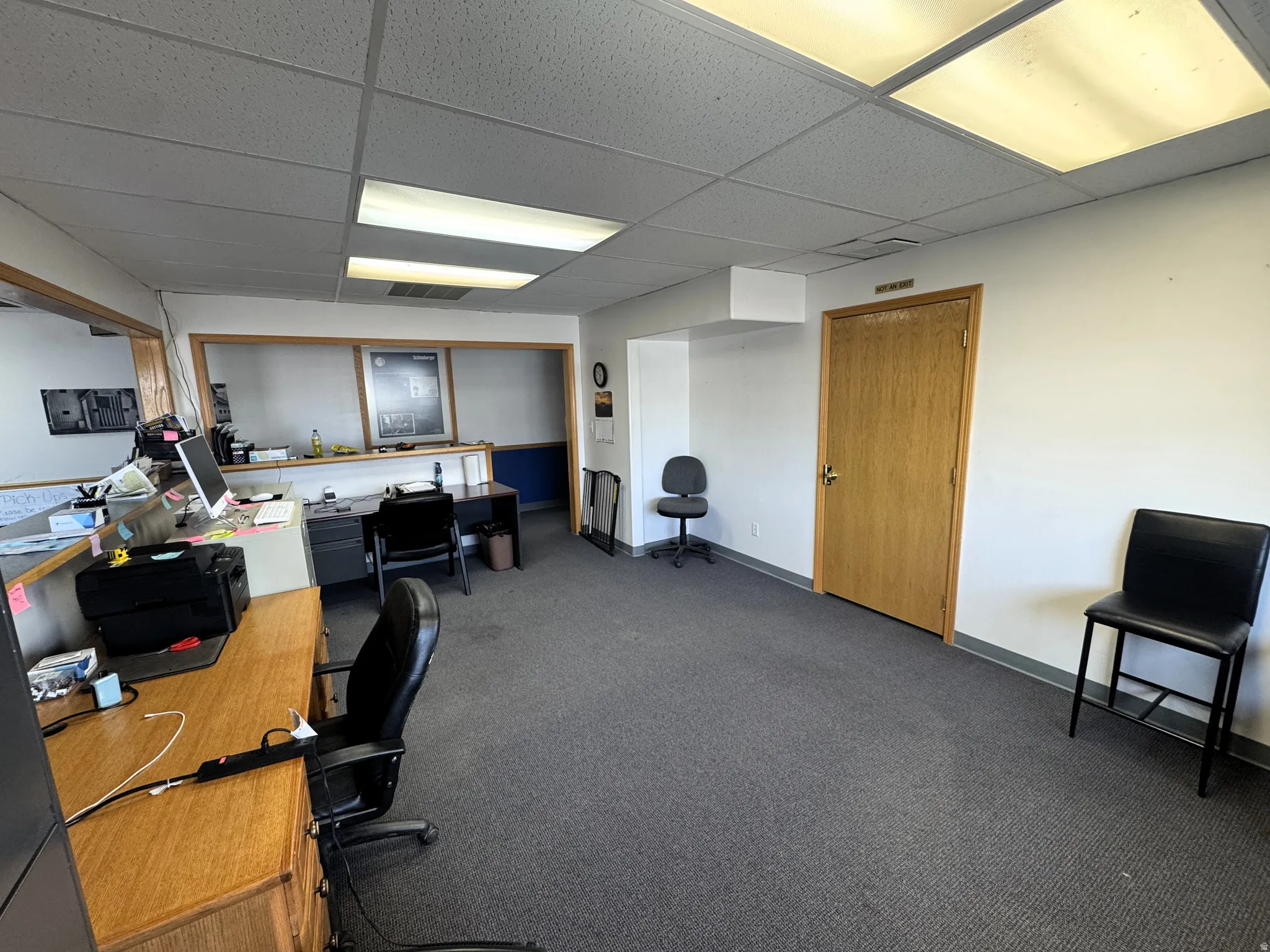 Office area with a paneled ceiling