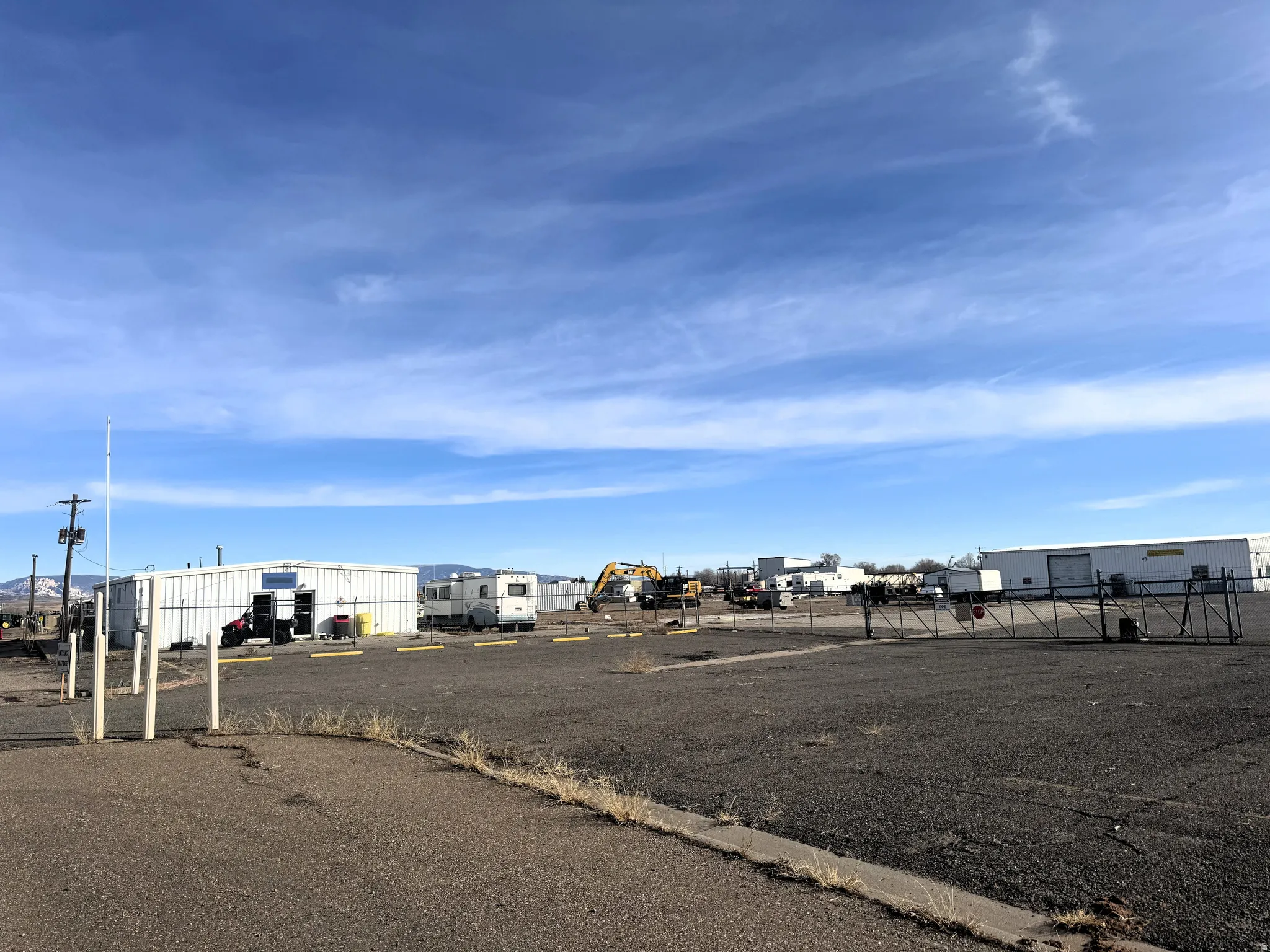 View of asphalt road with an outbuilding