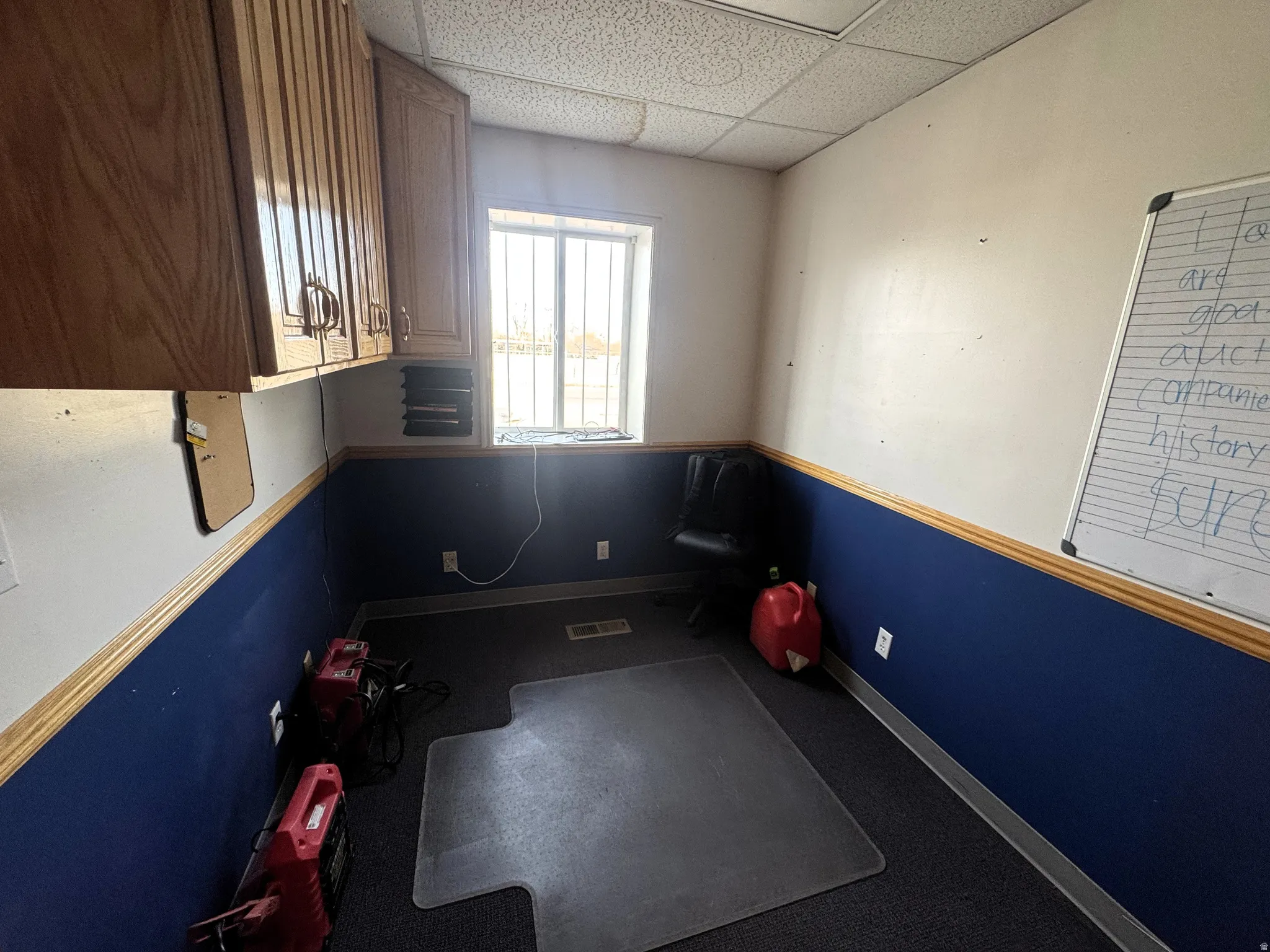 Interior space featuring baseboards and a drop ceiling