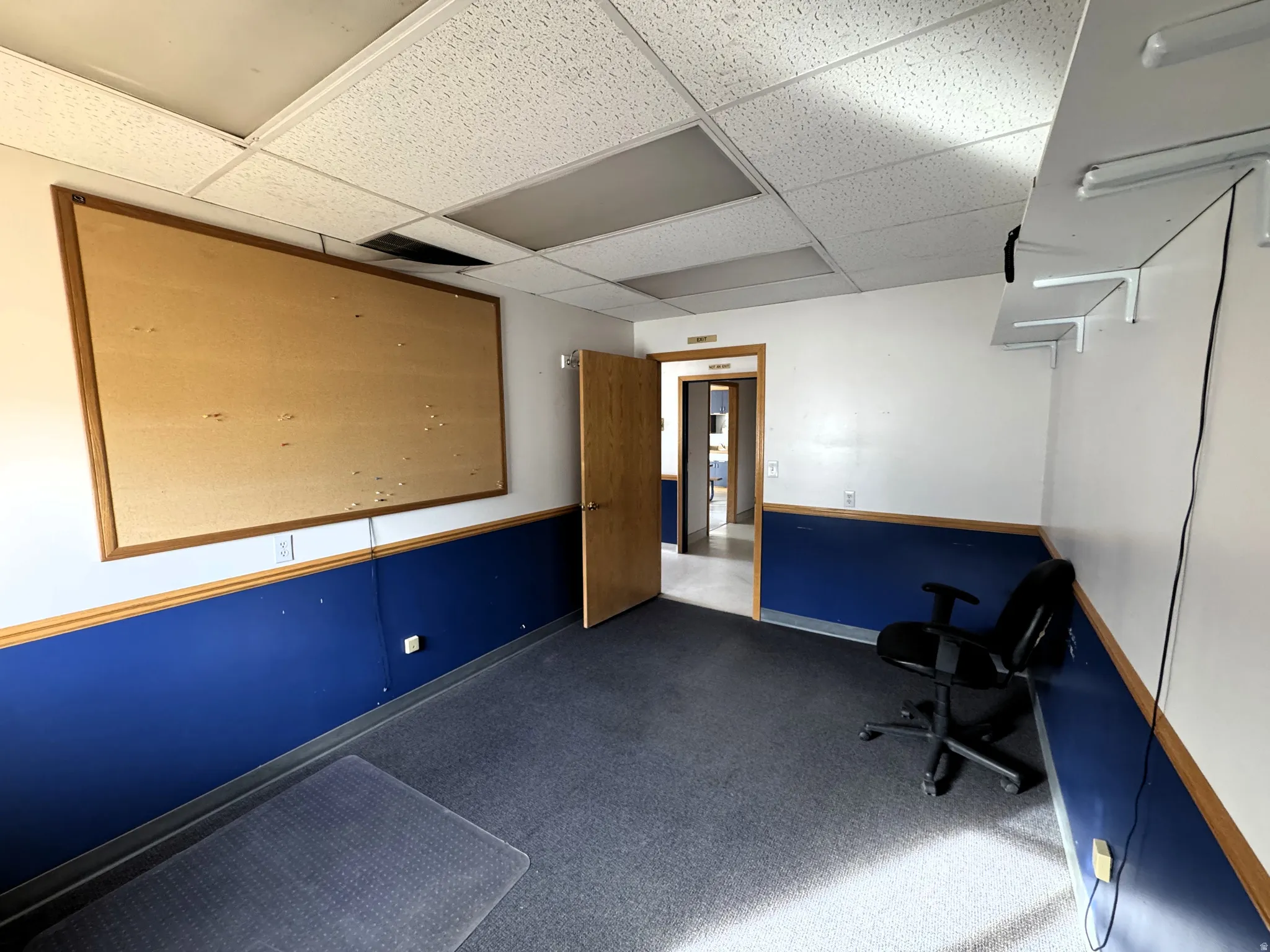 Unfurnished office featuring a drop ceiling