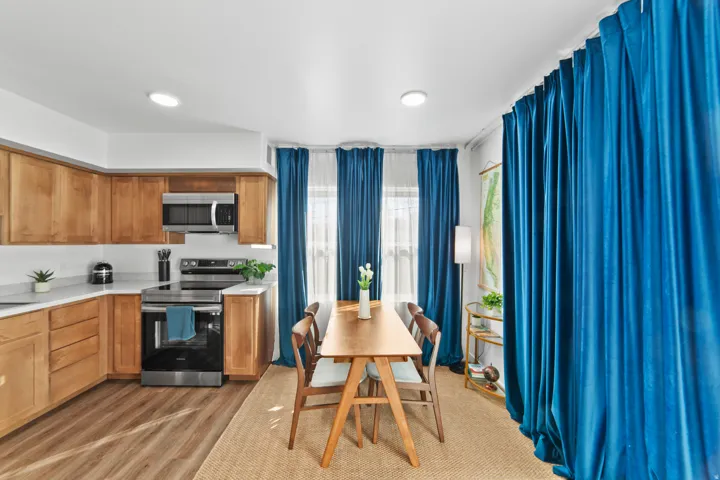 Kitchen with stainless steel appliances, light wood-style flooring, wood finish cabinetry, and recessed lighting