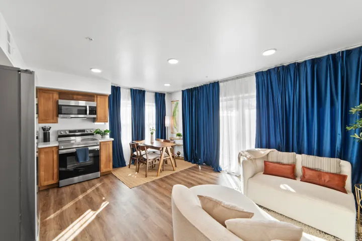 Living area featuring light wood finished floors, healthy amount of natural light, and recessed lighting
