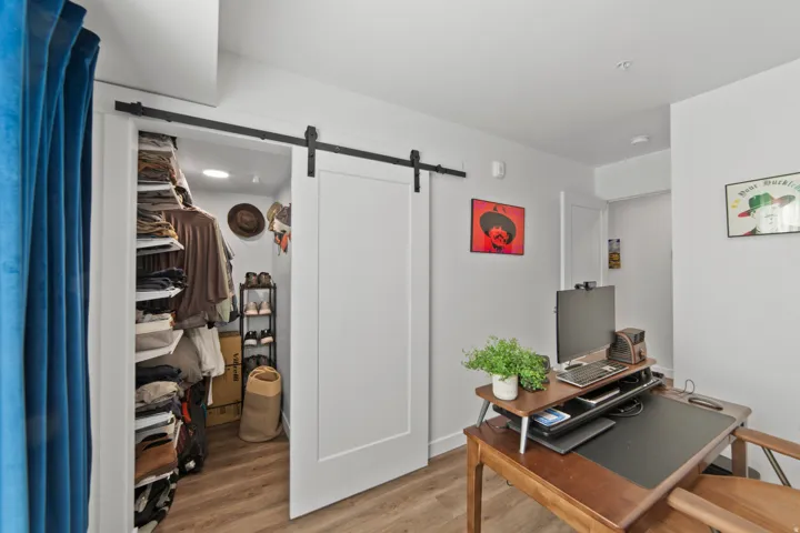 Office space featuring wood finished floors and a barn door